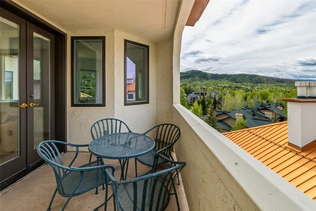 a kitchen with a table chairs sink and cabinets