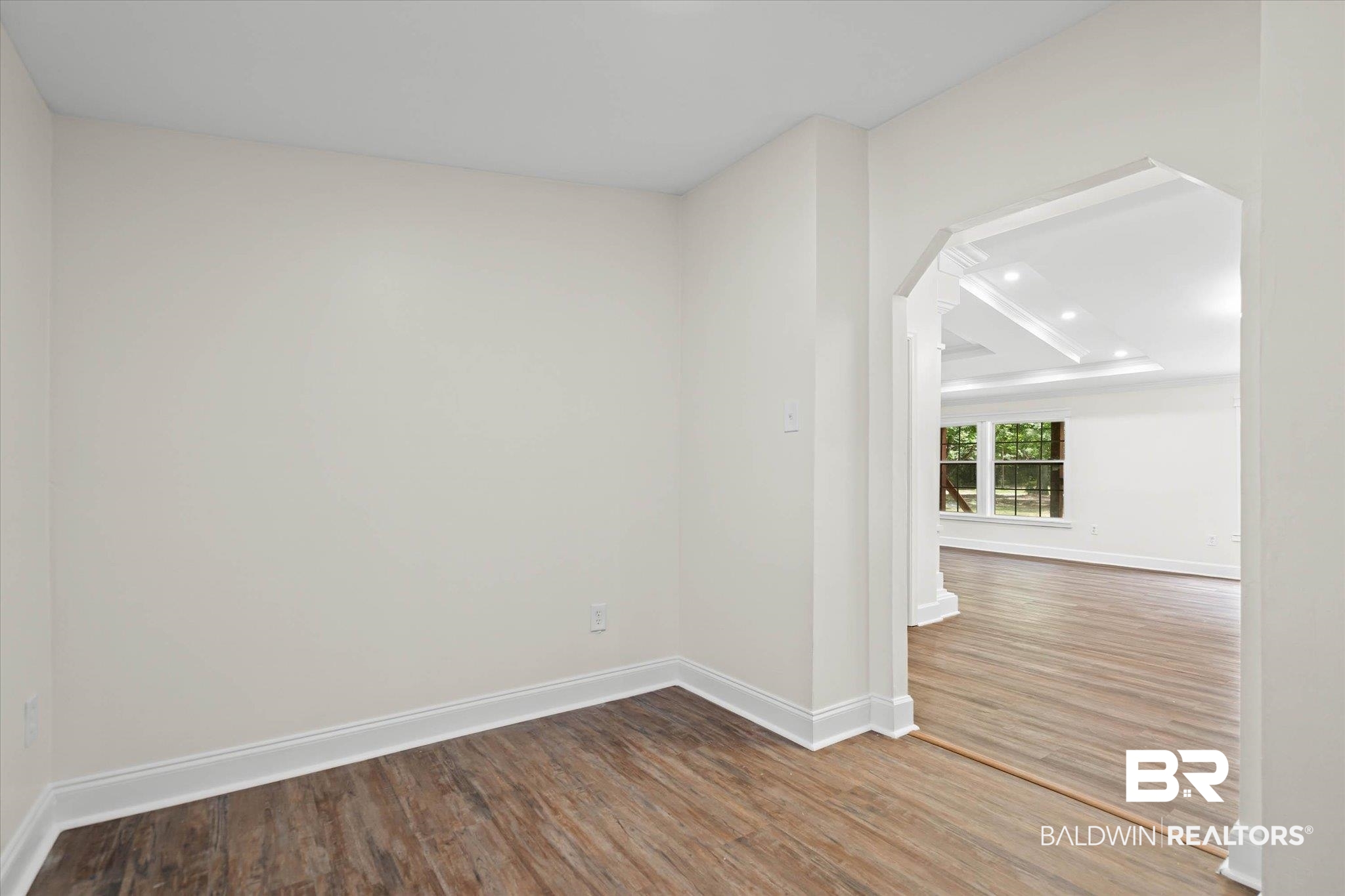 9230 McLeod Road Mobile, AL 36695 - Photo 7 of 20 Archway entry to a bright interior space featuring wood-finish flooring