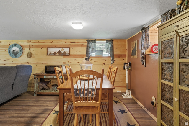 667 North Rapid Creek Road Inkom, ID 83245 - Photo 9 of 29 Wood-finish flooring anchors this dining area featuring wood plank wall accents and a contrasting accent wall