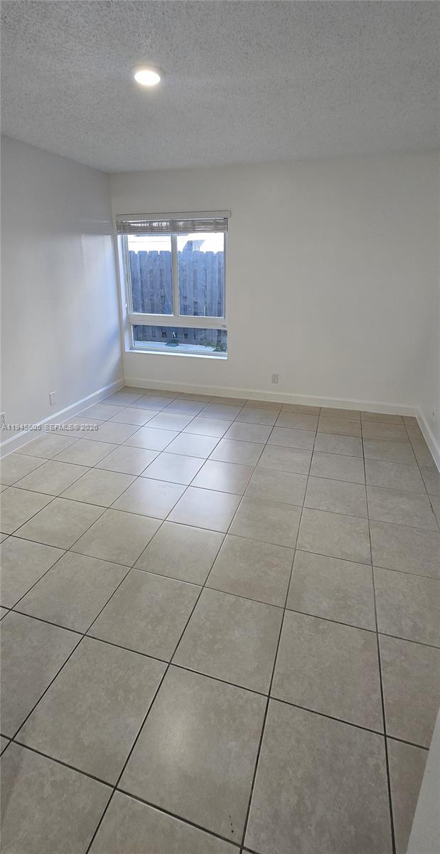 11150 Southwest 196th Street, Unit 104 Cutler Bay, FL 33157 - Photo 14 of 18 a view of an empty room and window