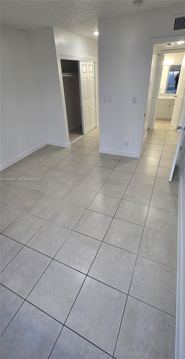 11150 Southwest 196th Street, Unit 104 Cutler Bay, FL 33157 - Photo 17 of 18 a view of an empty room and a window