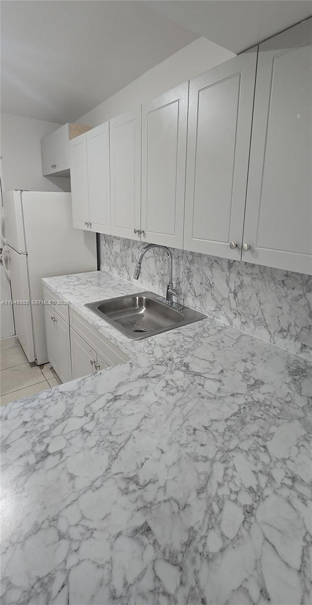 11150 Southwest 196th Street, Unit 104 Cutler Bay, FL 33157 - Photo 3 of 18 a kitchen with a sink cabinets and a stove