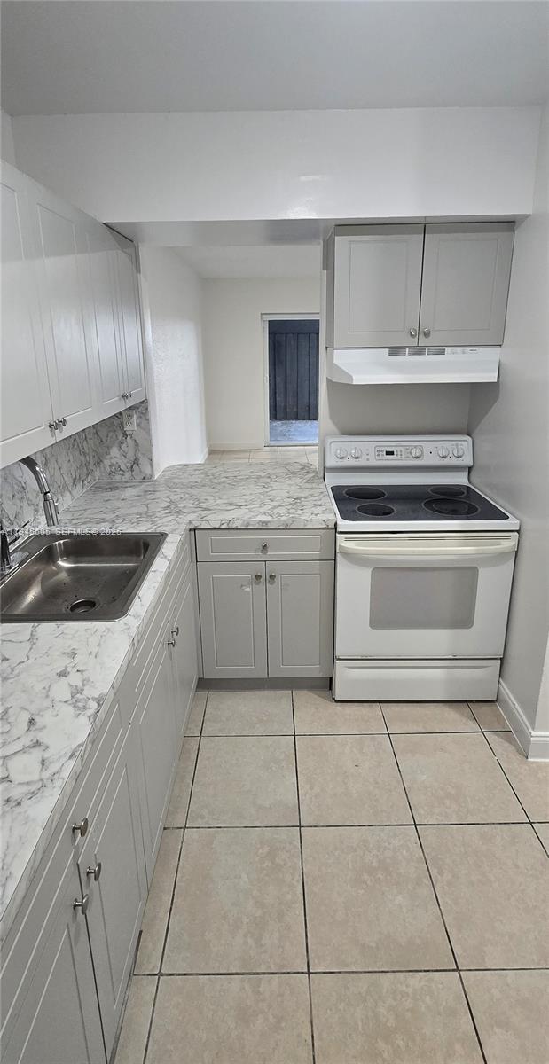 11150 Southwest 196th Street, Unit 104 Cutler Bay, FL 33157 - Photo 5 of 18 a kitchen with a stove sink and cabinets
