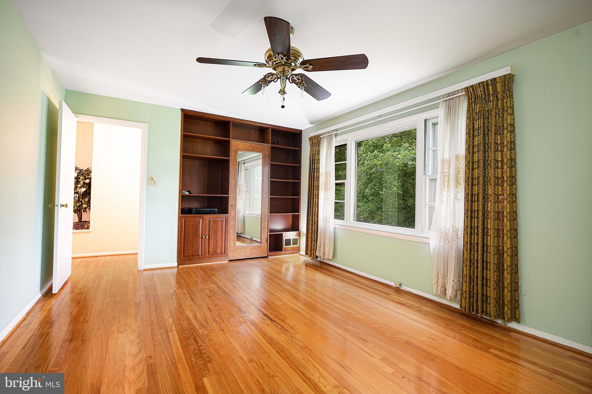 1607 Weyburn Road Rosedale, MD 21237 - Photo 14 of 36 a view of an empty room with a window and wooden floor