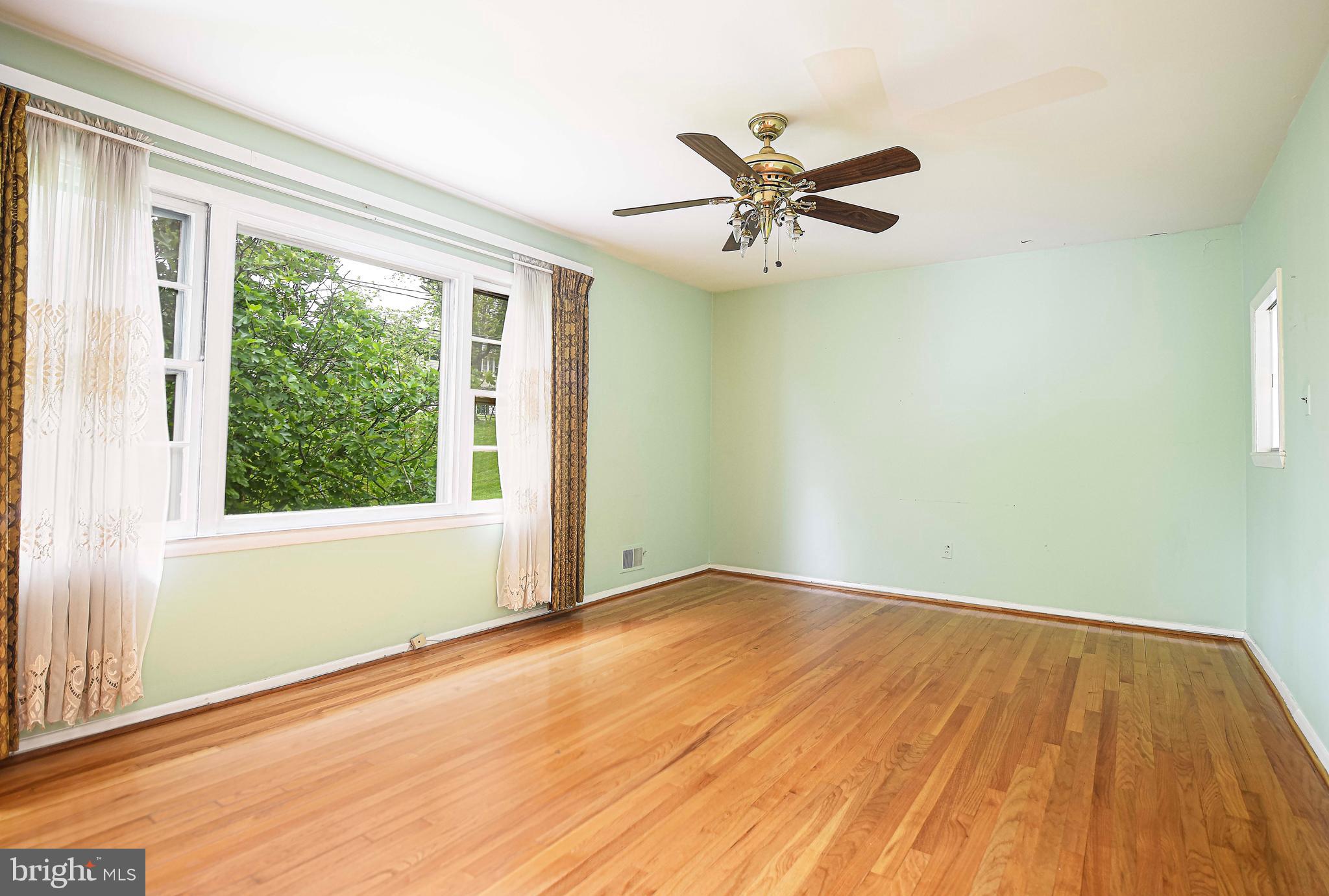 1607 Weyburn Road Rosedale, MD 21237 - Photo 15 of 36 a view of an empty room with wooden floor and a window