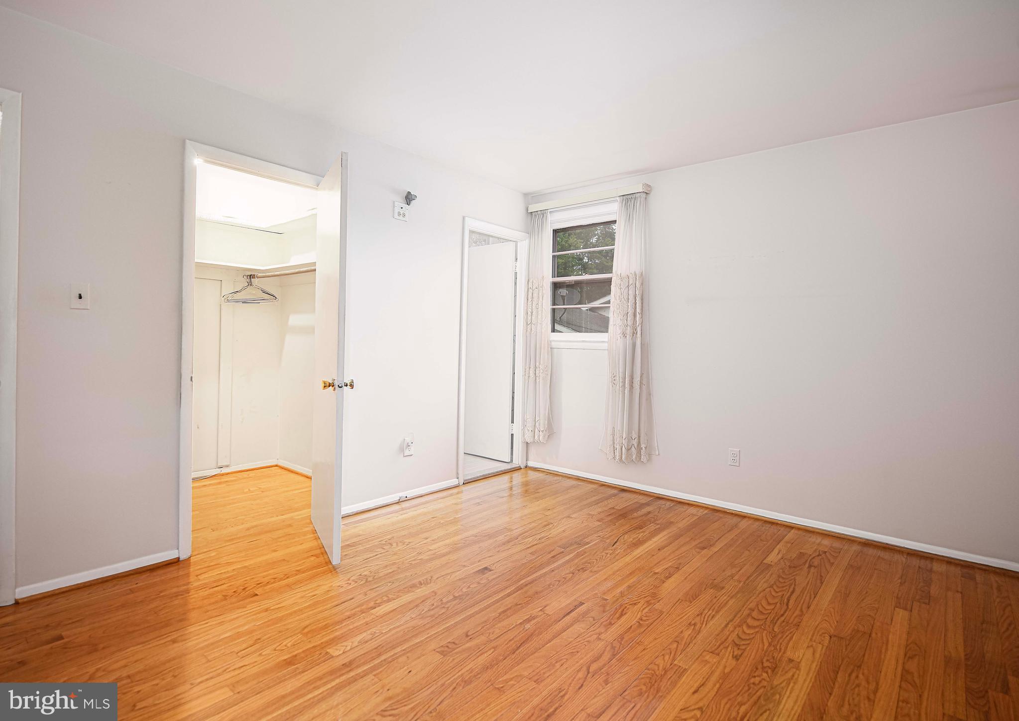 1607 Weyburn Road Rosedale, MD 21237 - Photo 21 of 36 an empty room with wooden floor and a window