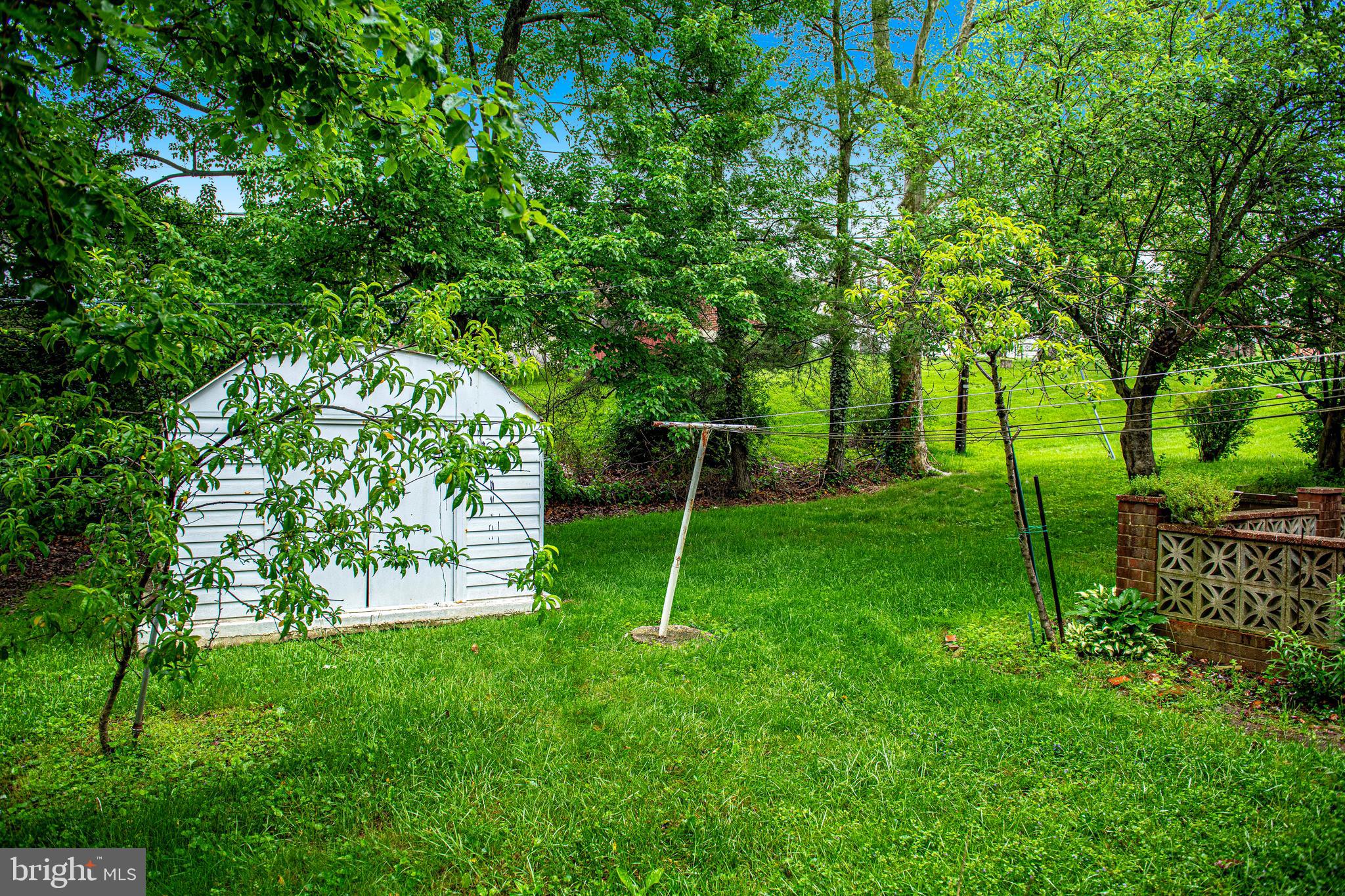 1607 Weyburn Road Rosedale, MD 21237 - Photo 33 of 36 a view of a backyard with a large tree