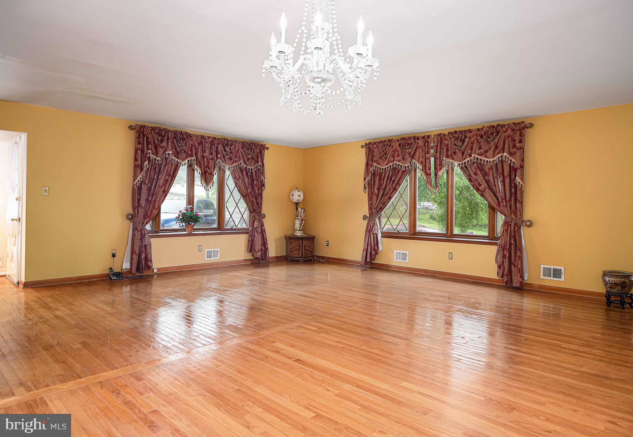 1607 Weyburn Road Rosedale, MD 21237 - Photo 7 of 36 an empty room with wooden floor and windows