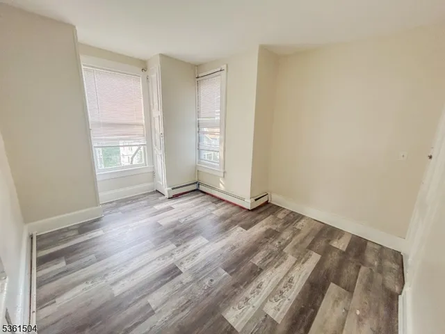a bathroom with a shower a toilet and a window