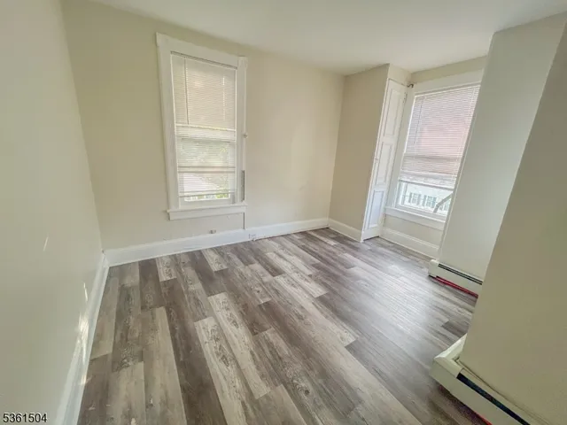 a bathroom with a granite countertop bathtub a shower and a window