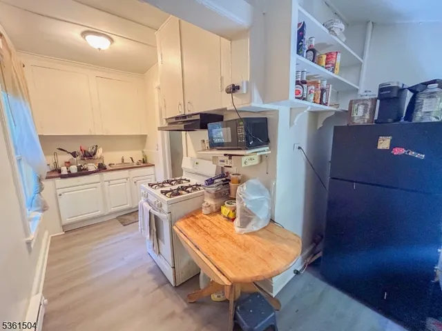 a bedroom with a bed dresser and window