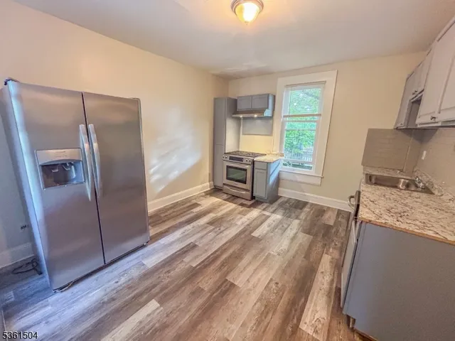 a kitchen with a stove a sink and a refrigerator