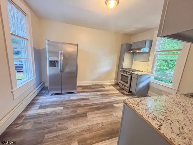 a view of a room with wooden floor and window
