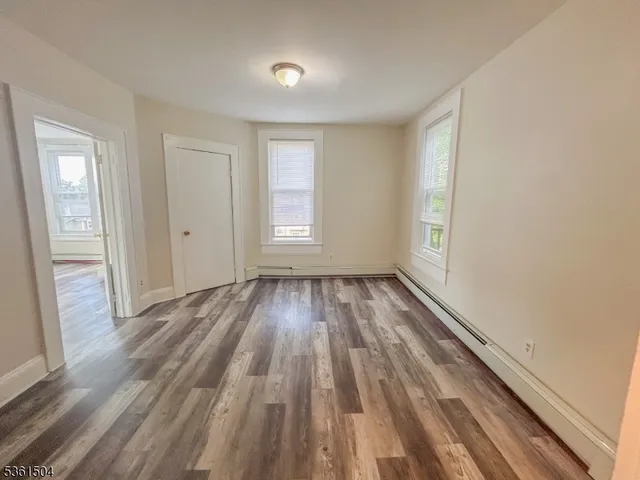 a view of a room with wooden floor and window