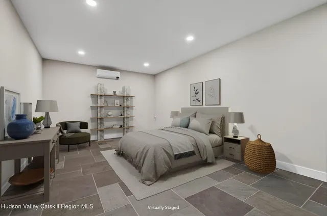 a bedroom with a bed and a couch