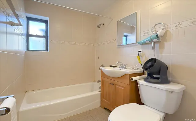 a bathroom with a sink a toilet and bathtub
