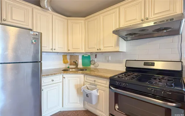 a kitchen with stainless steel appliances granite countertop a stove a refrigerator and a microwave