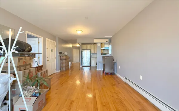 a view of a room with wooden floor and bench