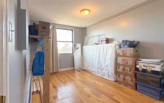 a view of a kitchen with wooden floor and a refrigerator