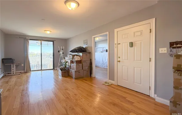 a empty room with furniture and wooden floor
