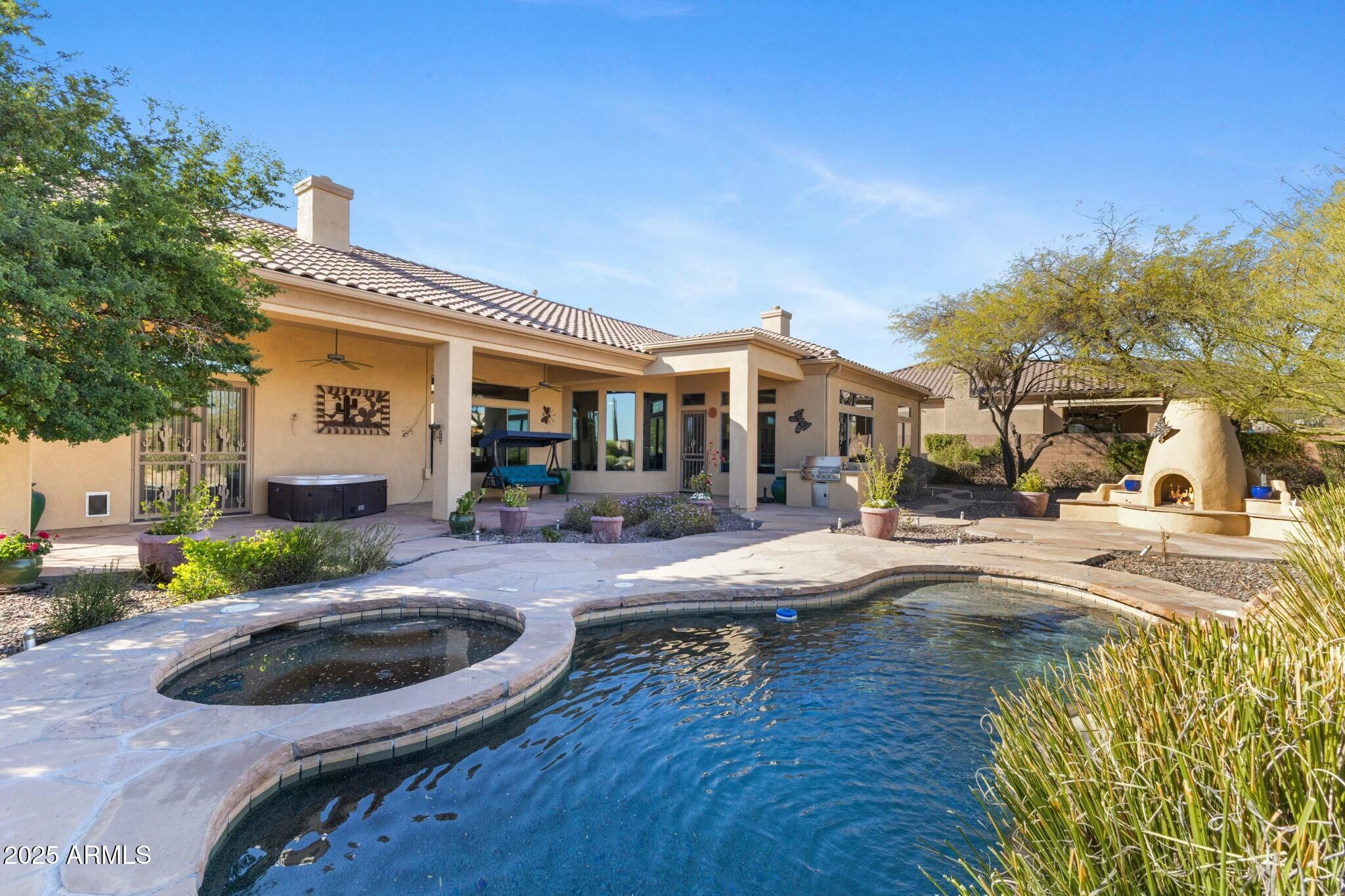 41601 North River Bend Road Anthem, AZ 85086 - Photo 1 of 97 a view of a house with swimming pool and sitting area