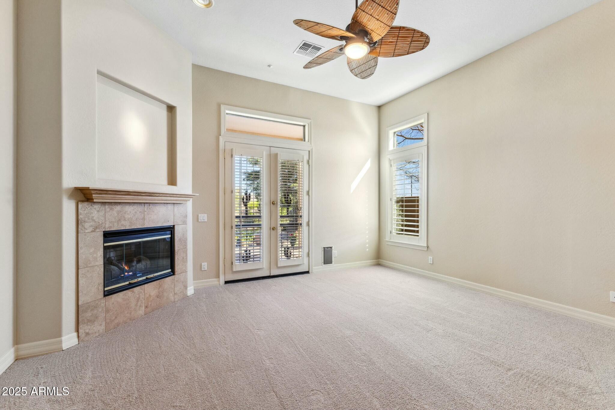 41601 North River Bend Road Anthem, AZ 85086 - Photo 12 of 97 a view of a livingroom with a fireplace and a ceiling fan
