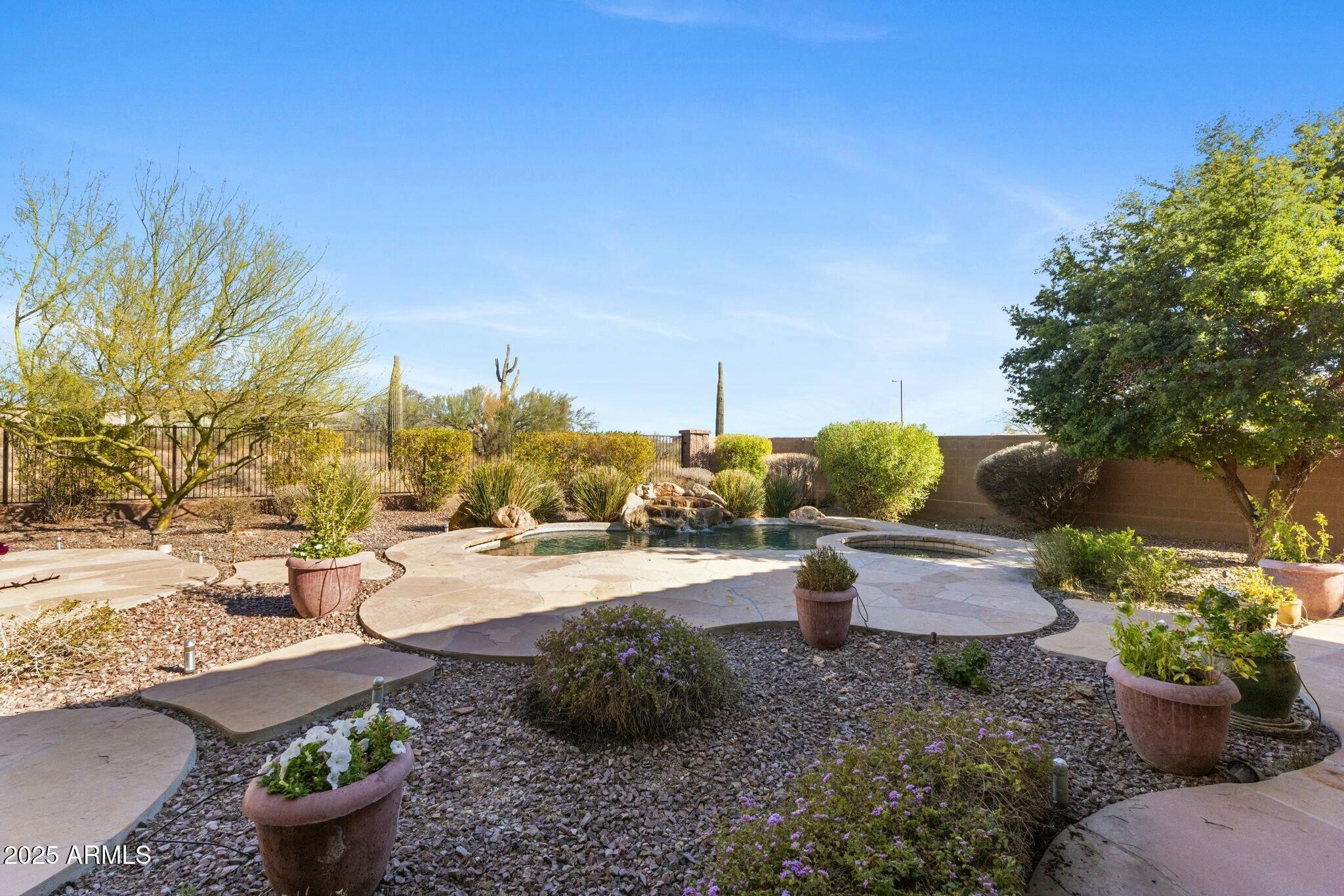 41601 North River Bend Road Anthem, AZ 85086 - Photo 26 of 97 a view of a backyard with chair and potted plants