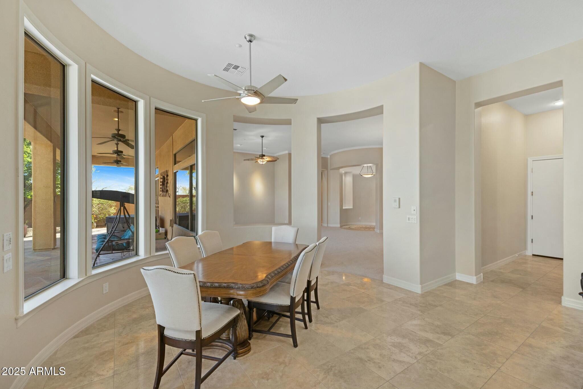 41601 North River Bend Road Anthem, AZ 85086 - Photo 44 of 97 a view of a dining room with furniture and a chandelier