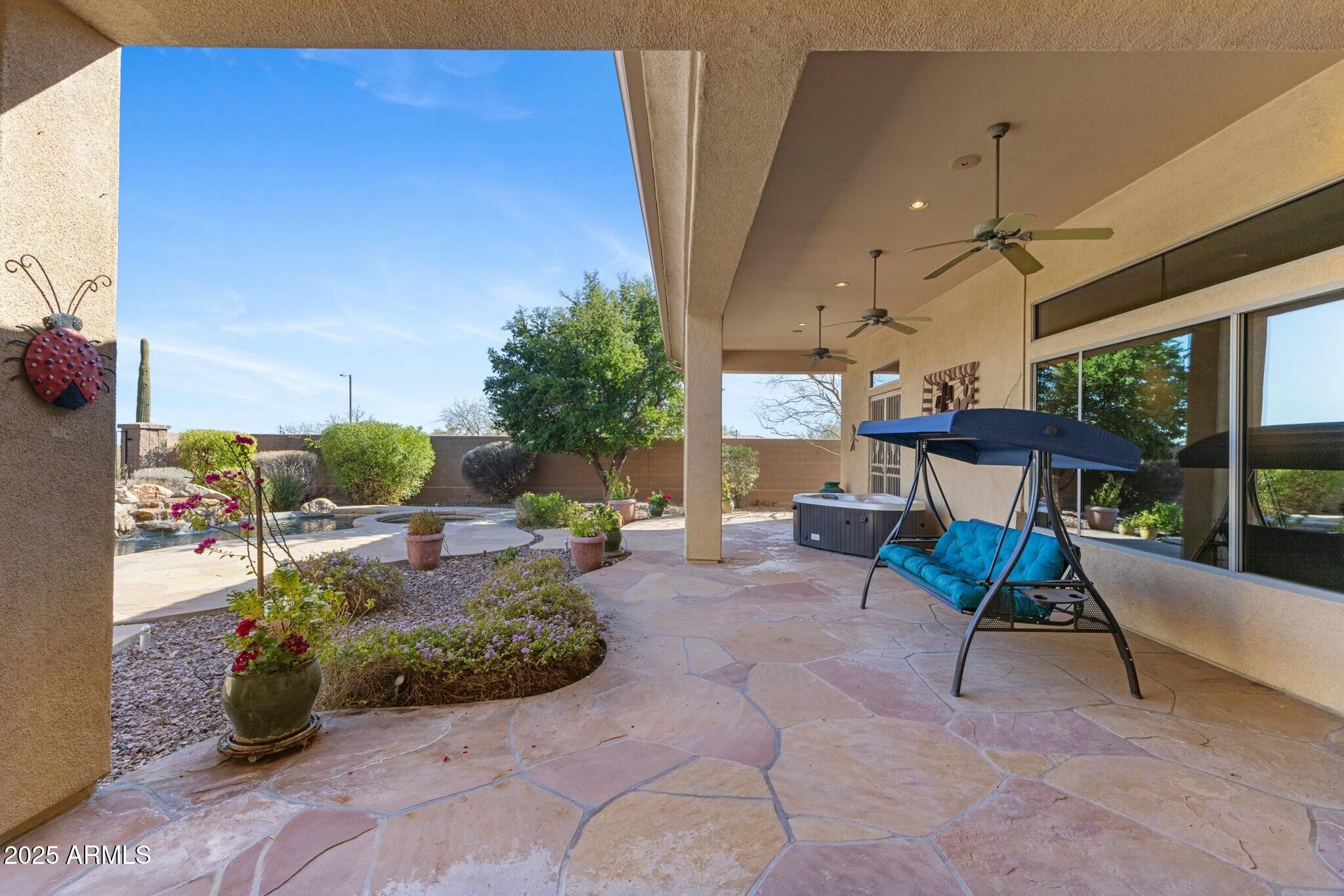 41601 North River Bend Road Anthem, AZ 85086 - Photo 50 of 97 a view of a patio with table and chairs potted plants with wooden floor