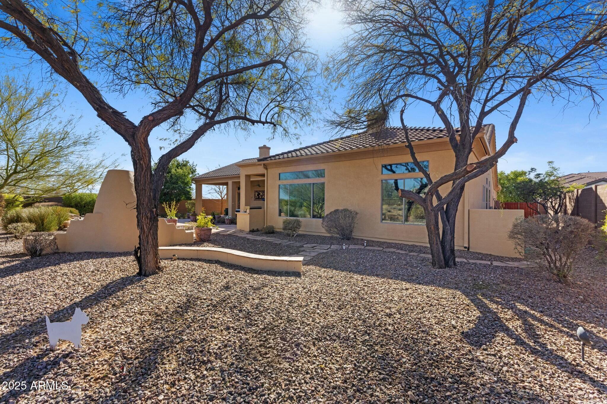 41601 North River Bend Road Anthem, AZ 85086 - Photo 55 of 97 a view of a house with backyard and a tree