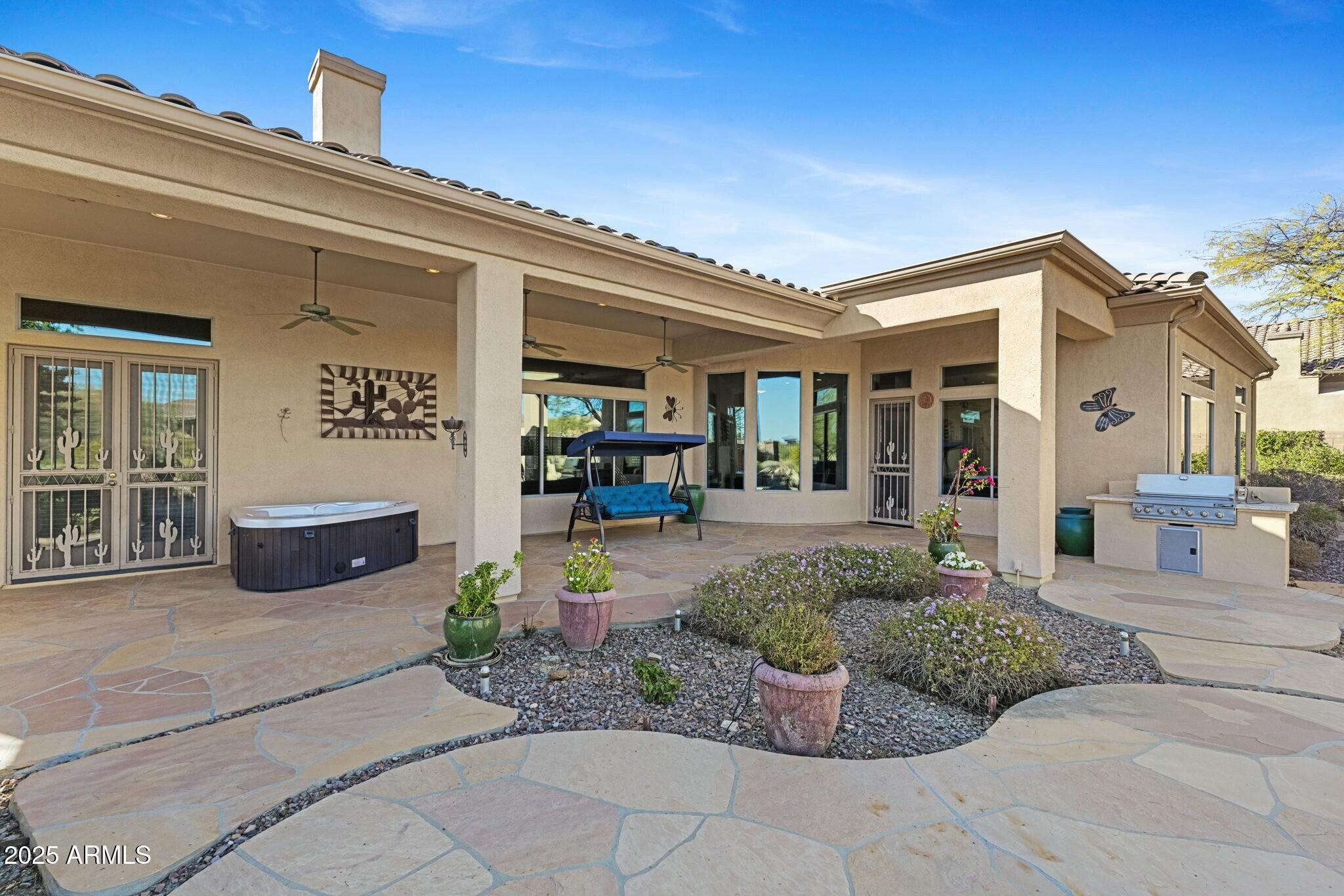 41601 North River Bend Road Anthem, AZ 85086 - Photo 61 of 97 a view of a patio with couches table and chairs and potted plants