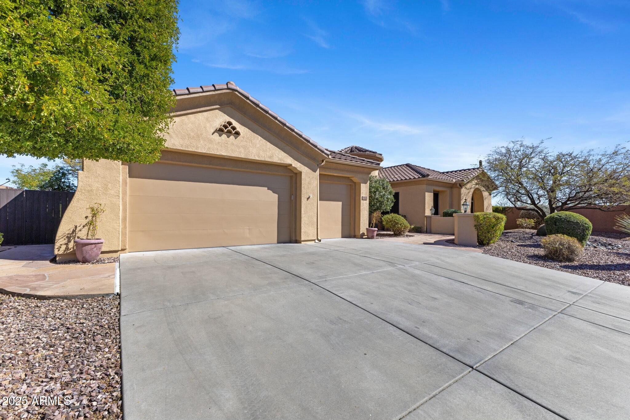 41601 North River Bend Road Anthem, AZ 85086 - Photo 7 of 97 a front view of a house with a yard and garage
