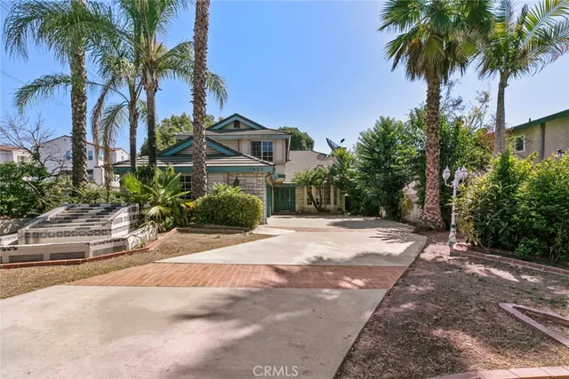 a front view of a house with a garden and a yard