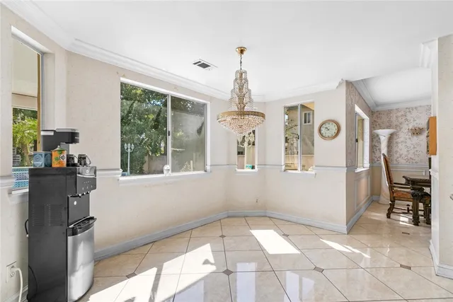 a view of a hallway with windows and chandelier