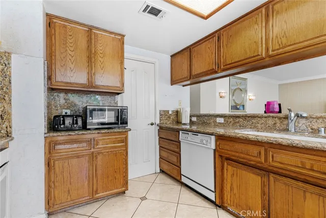 a kitchen with stainless steel appliances granite countertop a stove sink and cabinets