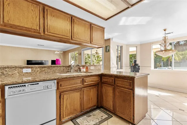 a kitchen with granite countertop a sink and cabinets