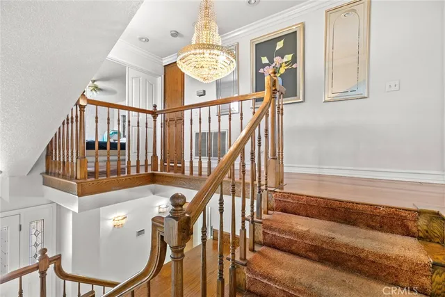 a view of staircase with railing and white walls