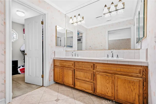 a spacious bathroom with a double vanity sink a mirror and a shower