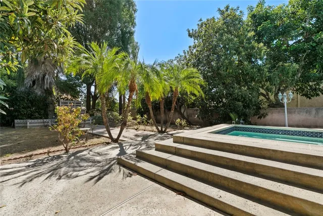 a view of a building with backyard and sitting area