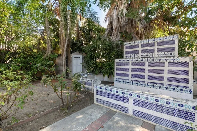 a view of a patio with table and chairs and potted plants