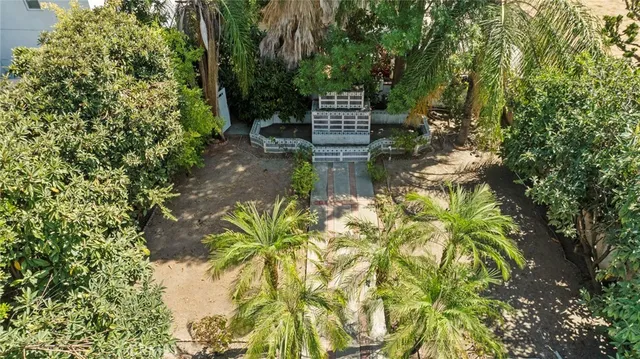 an aerial view of a house with a yard table and chairs