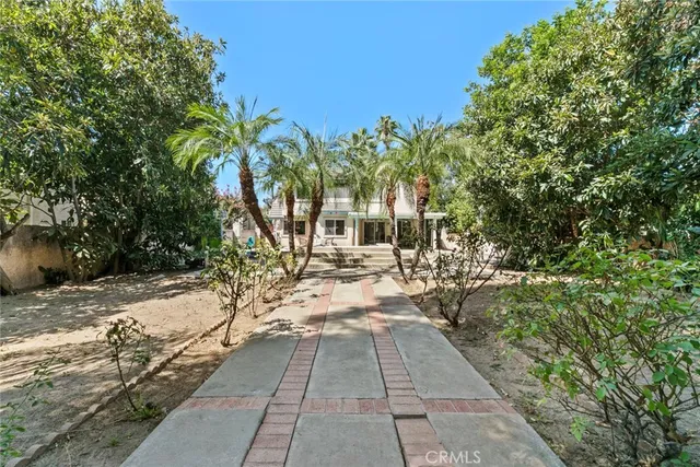 an aerial view of a house with a yard and garden
