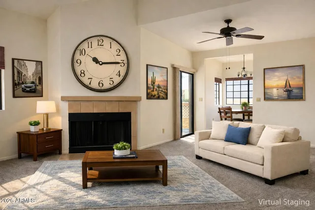 a living room with furniture a clock and a fireplace