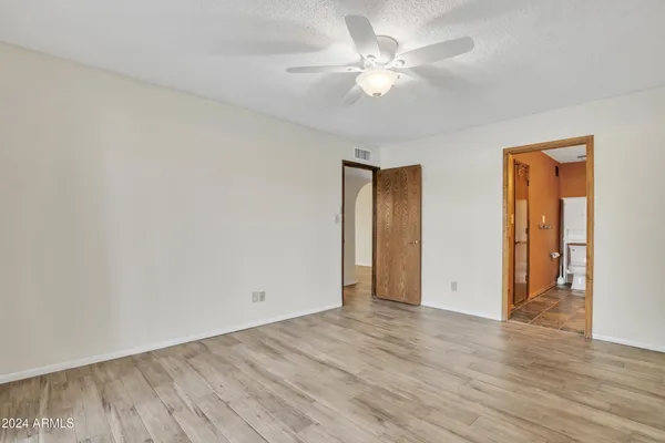 a bathroom with a granite countertop toilet sink shower and mirror