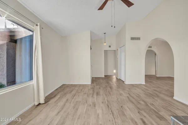 a view of empty room with wooden floor