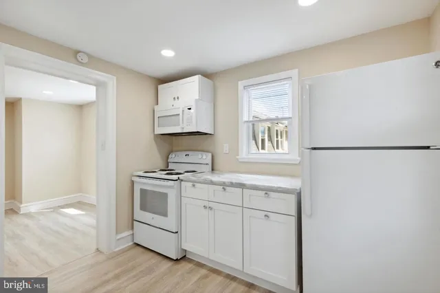 a kitchen with a stove a sink and a refrigerator