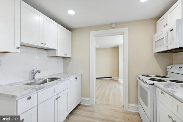 a kitchen with stainless steel appliances granite countertop a sink and a stove