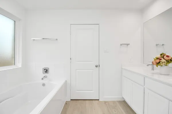 a bathroom with a sink mirror and vanity