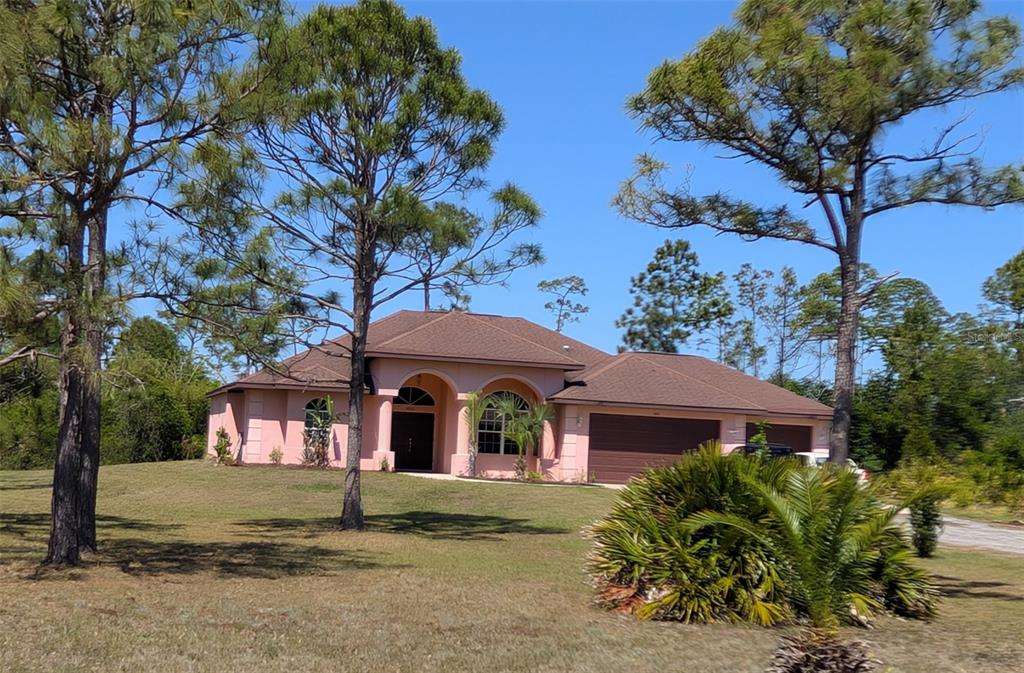 a view of house with yard