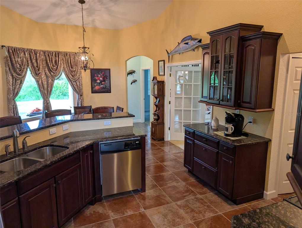 8511 Austrian Boulevard Punta Gorda, FL 33982 - Photo 11 of 20 a kitchen with stainless steel appliances granite countertop a stove and a sink